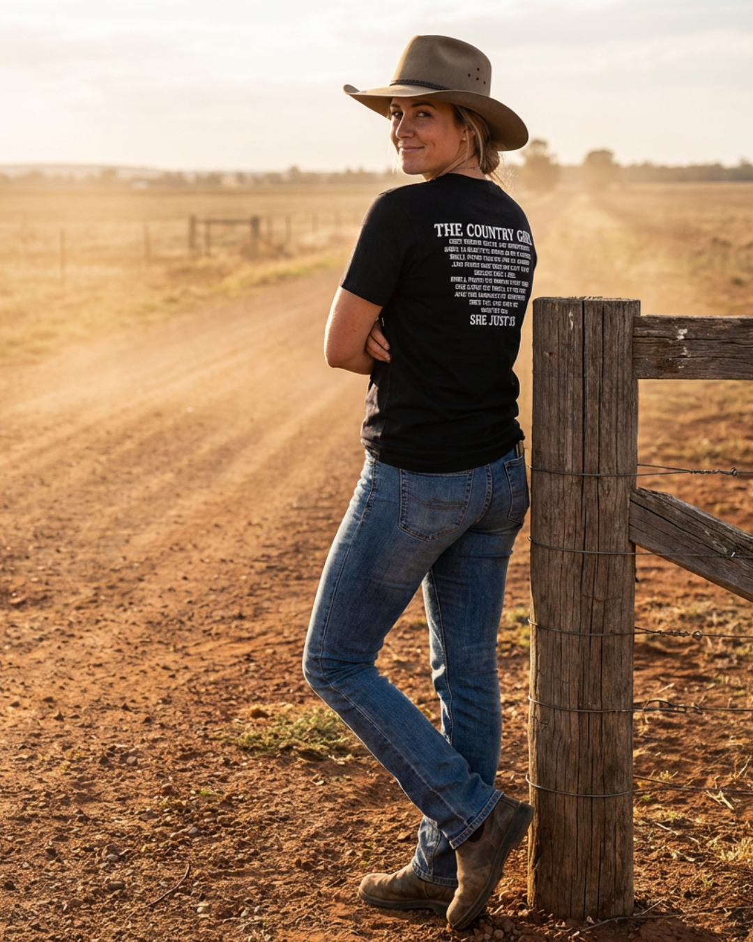Female model wearing Sunburnt Country Clothing The country girl tee in rural paddock setting