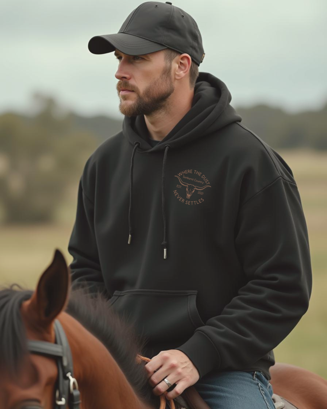 Front of a Male model wearing Sunburnt Country Clothing Heritage hoodie in rural setting