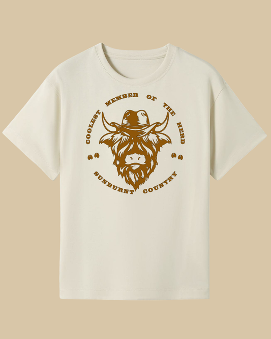 Front of a natural coloured boys country western t-shirt highland cow design by Sunburnt Country Clothing, Australian kids country clothing