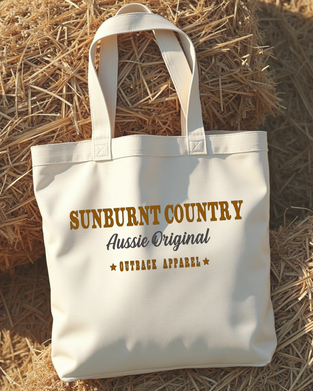 Sunburnt Country Clothing canvas tote bag with 'Sunburnt Country' text on a hay background