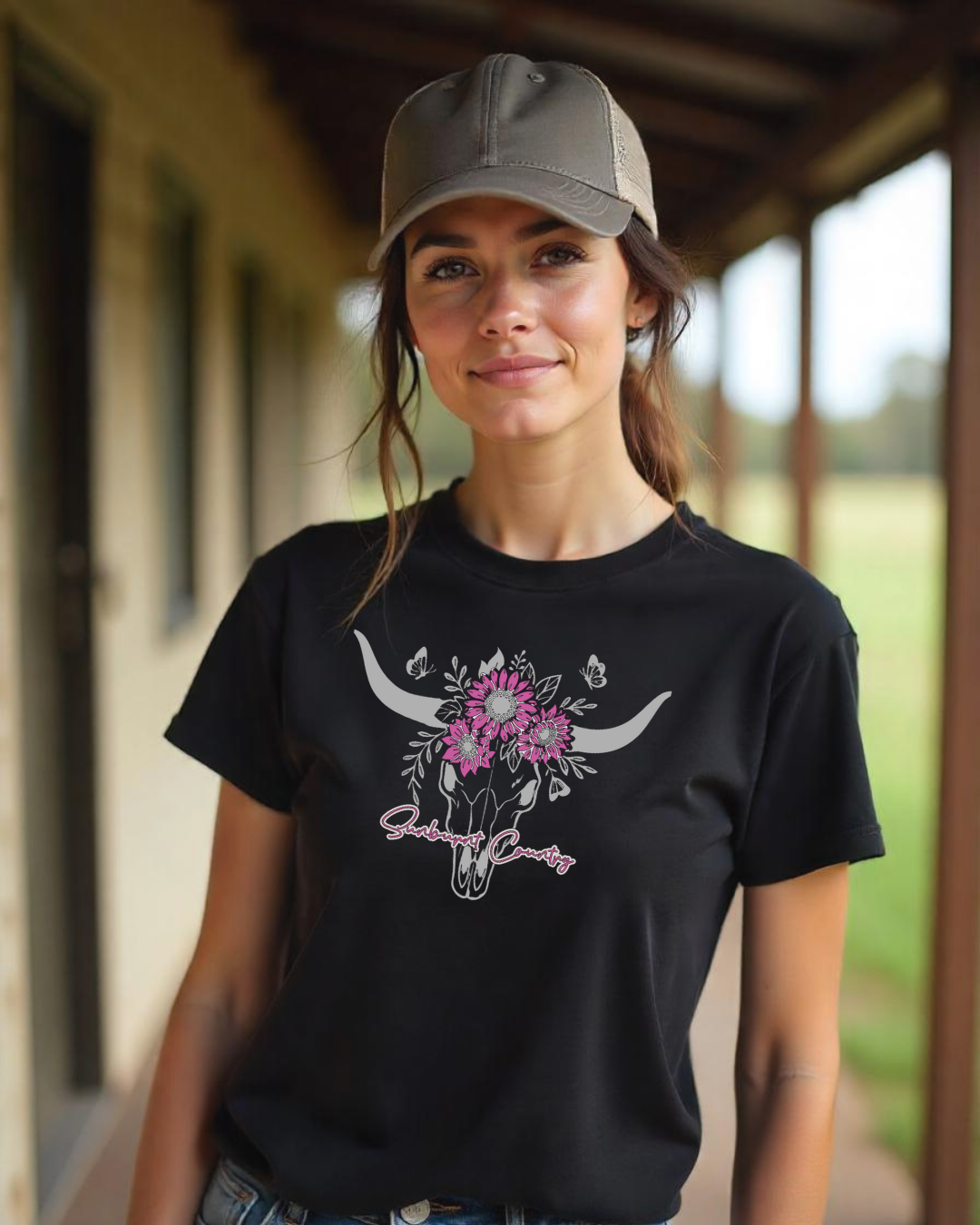 Female model wearing Sunburnt Country Clothing country soul tee longhorn skull with flowers and butterflies black country t-shirt front print