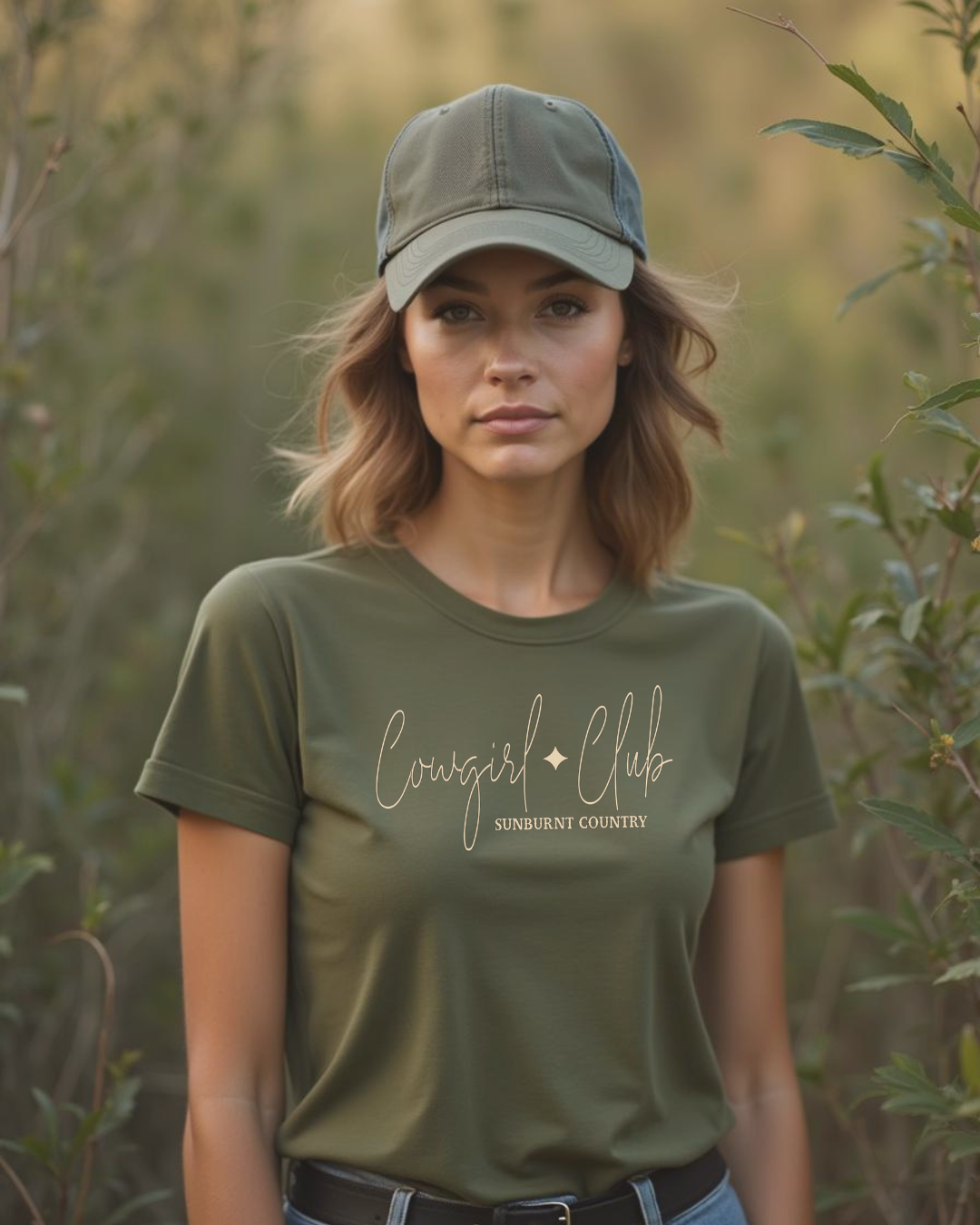 Female model wearing Sunburnt Country Clothing country t-shirt the cowgirl club in a bush setting