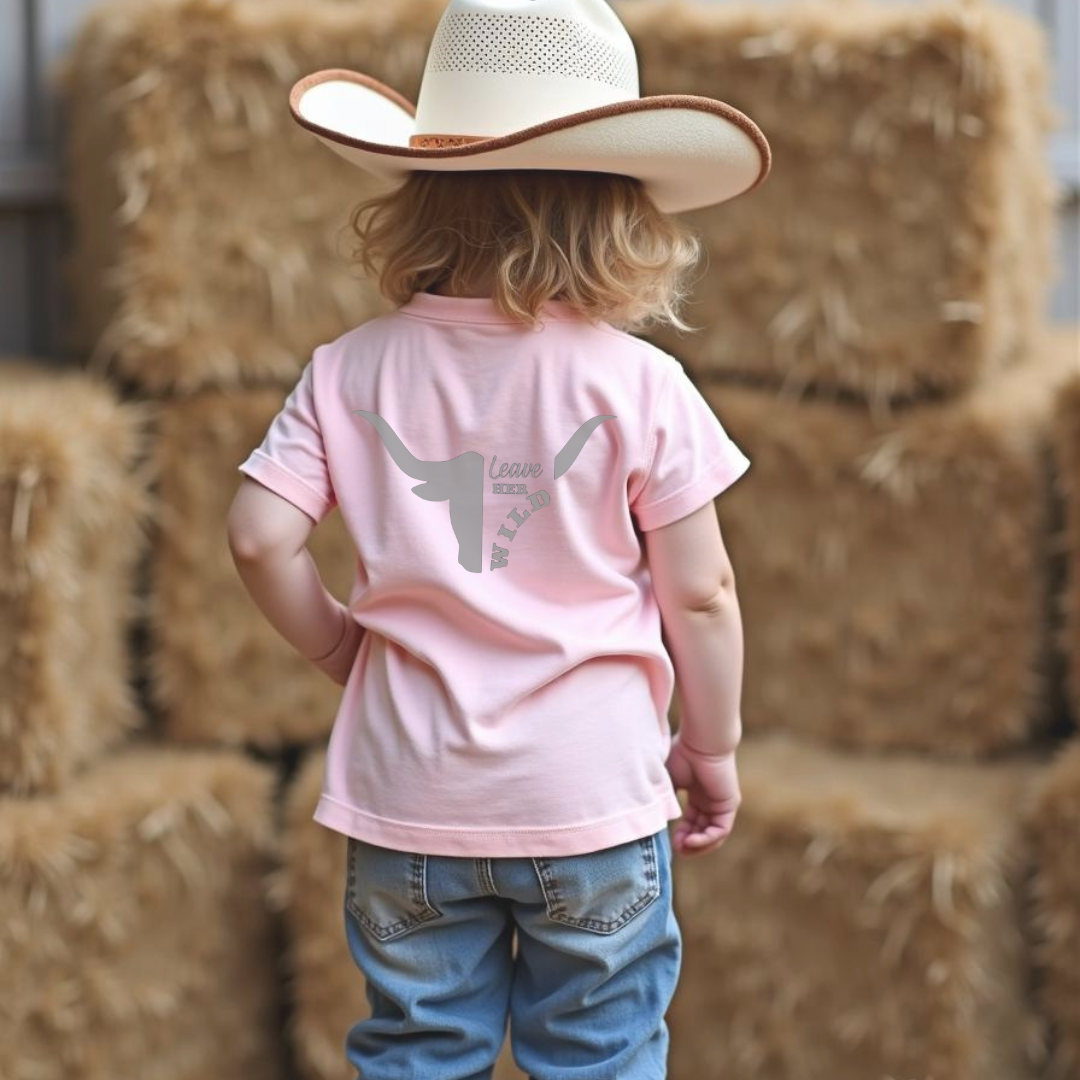 Back of young cowgirl girl with pink girls country western t-shirt with skull and text design by Sunburnt Country Clothing, Australian kids country clothing
