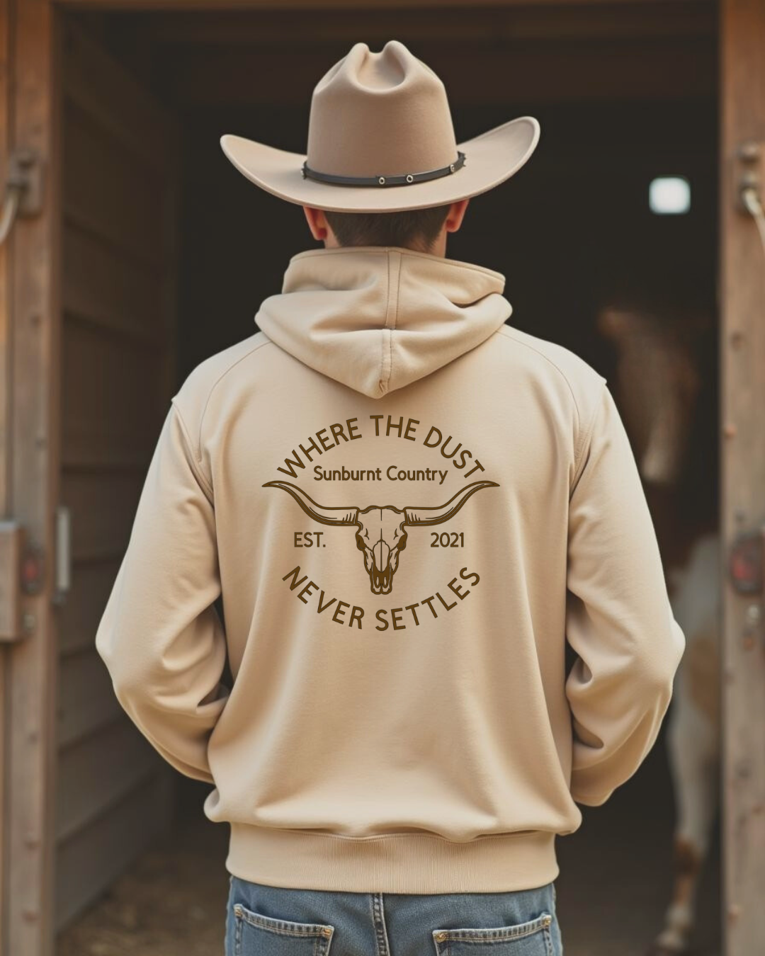 Back of a Male model wearing Sunburnt Country Clothing sand Heritage hoodie in rural setting