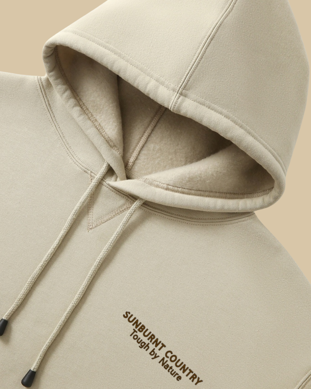 Sunburnt Country Clothing Sand hoodie  close-up with text on the front
