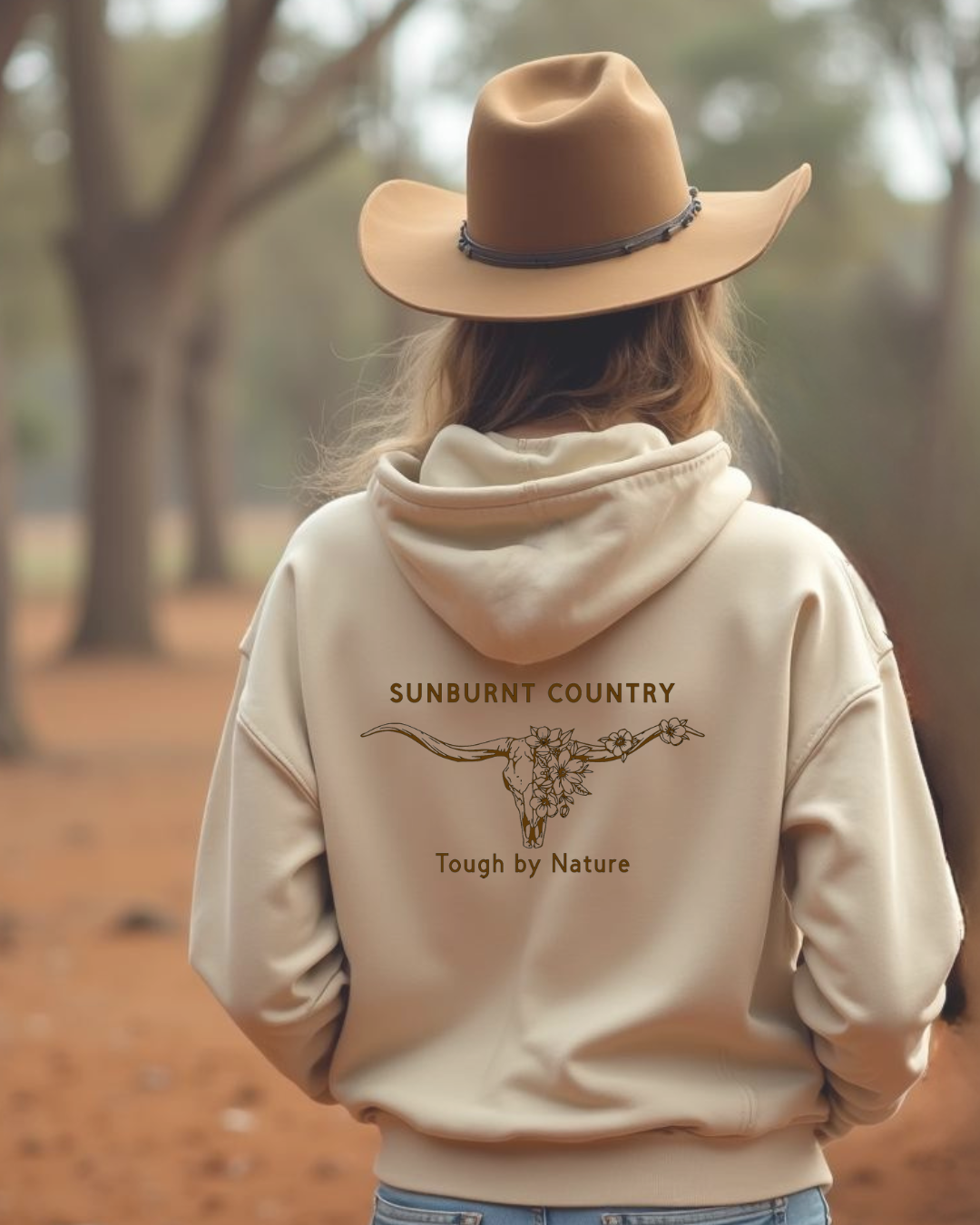 Back view of Female model wearing Sunburnt Country Clothing sand tough by nature hoodie in rural setting